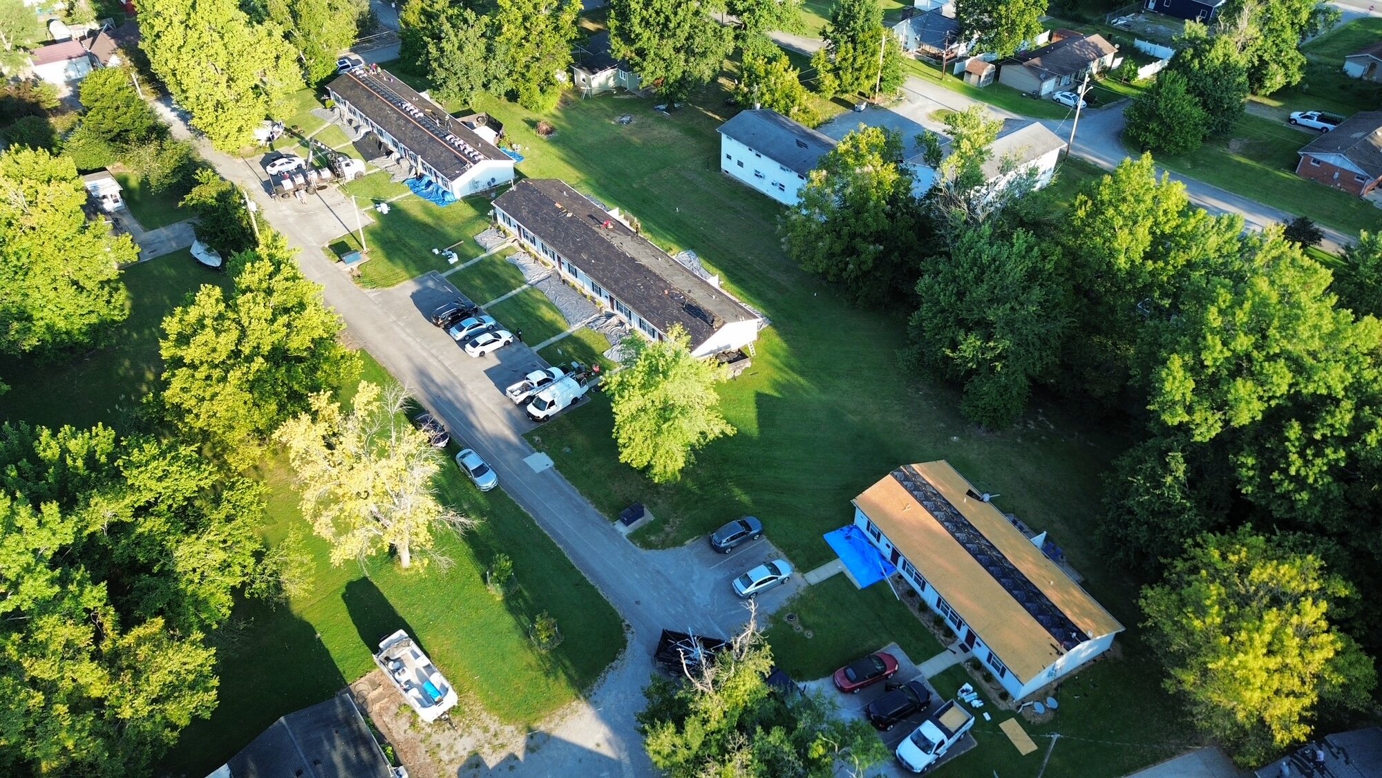 Wide aerial view of a multi-building roofing project