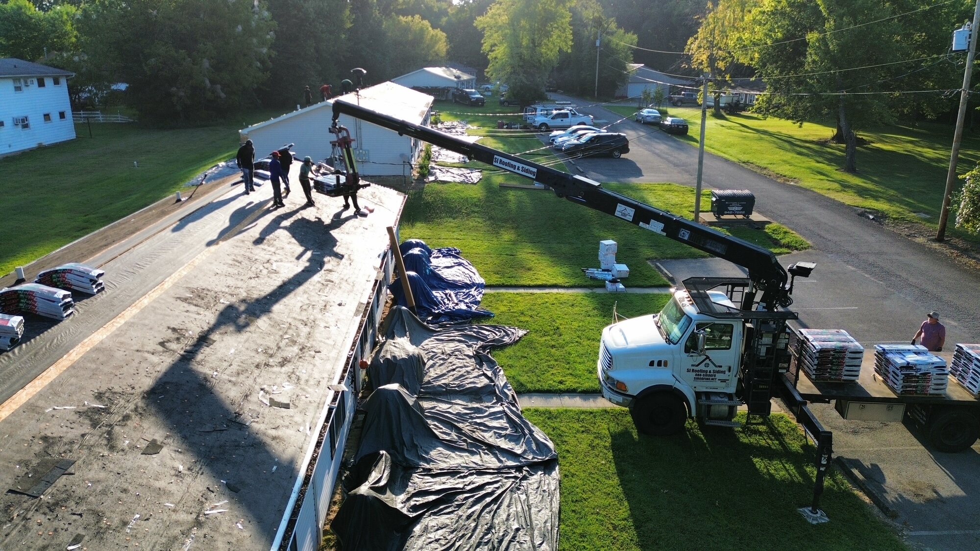 High aerial view of the roofing project and surrounding neighborhood