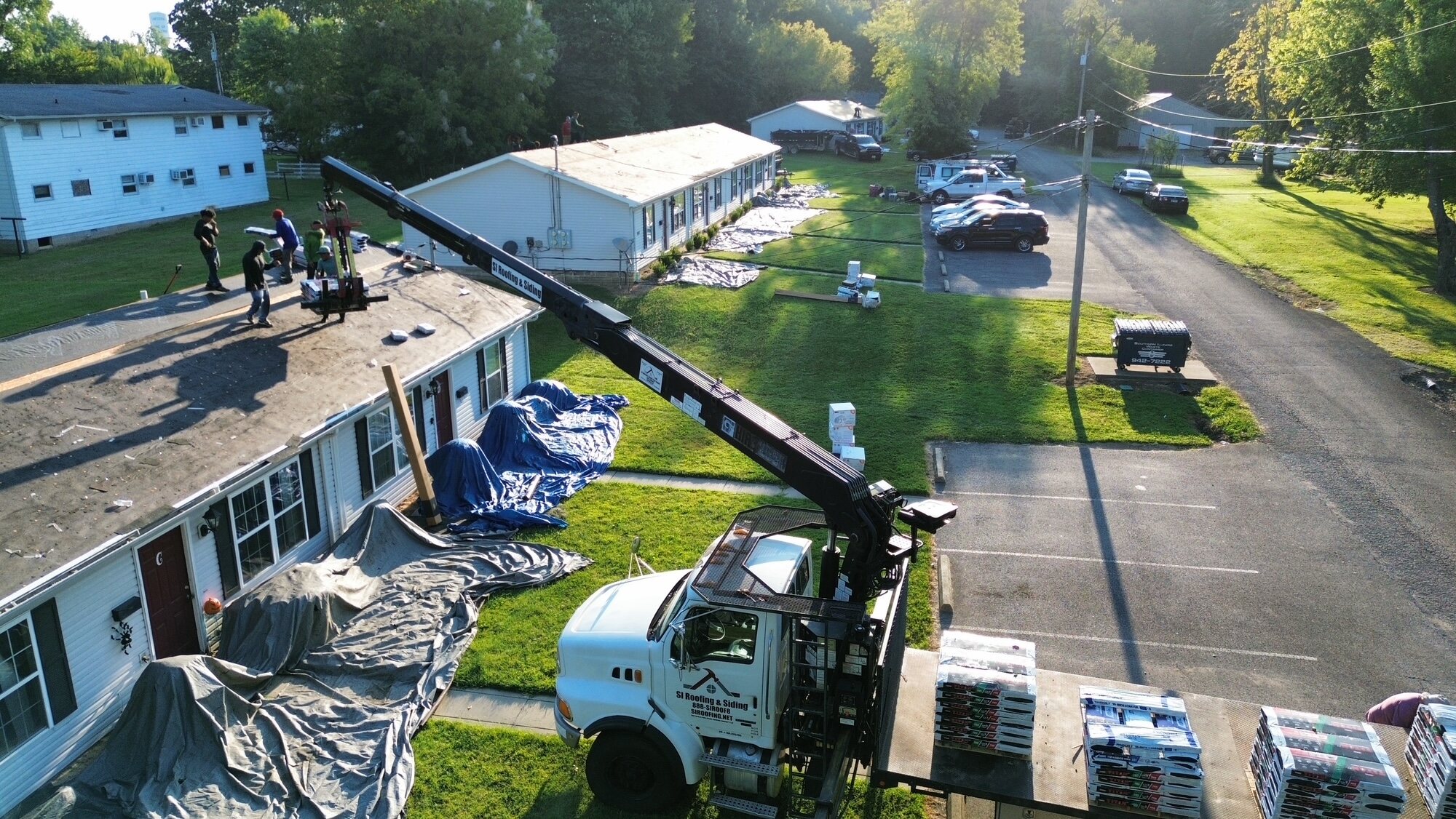 Aerial view of roof preparation on neighboring buildings