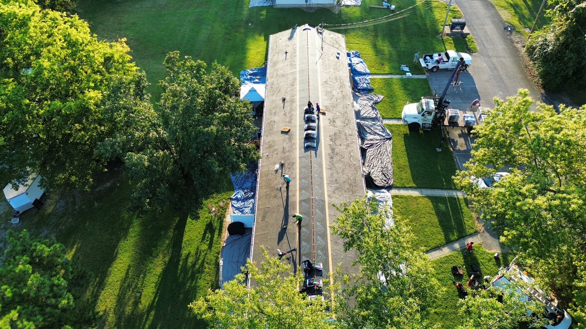 Roofing material delivery during an active installation